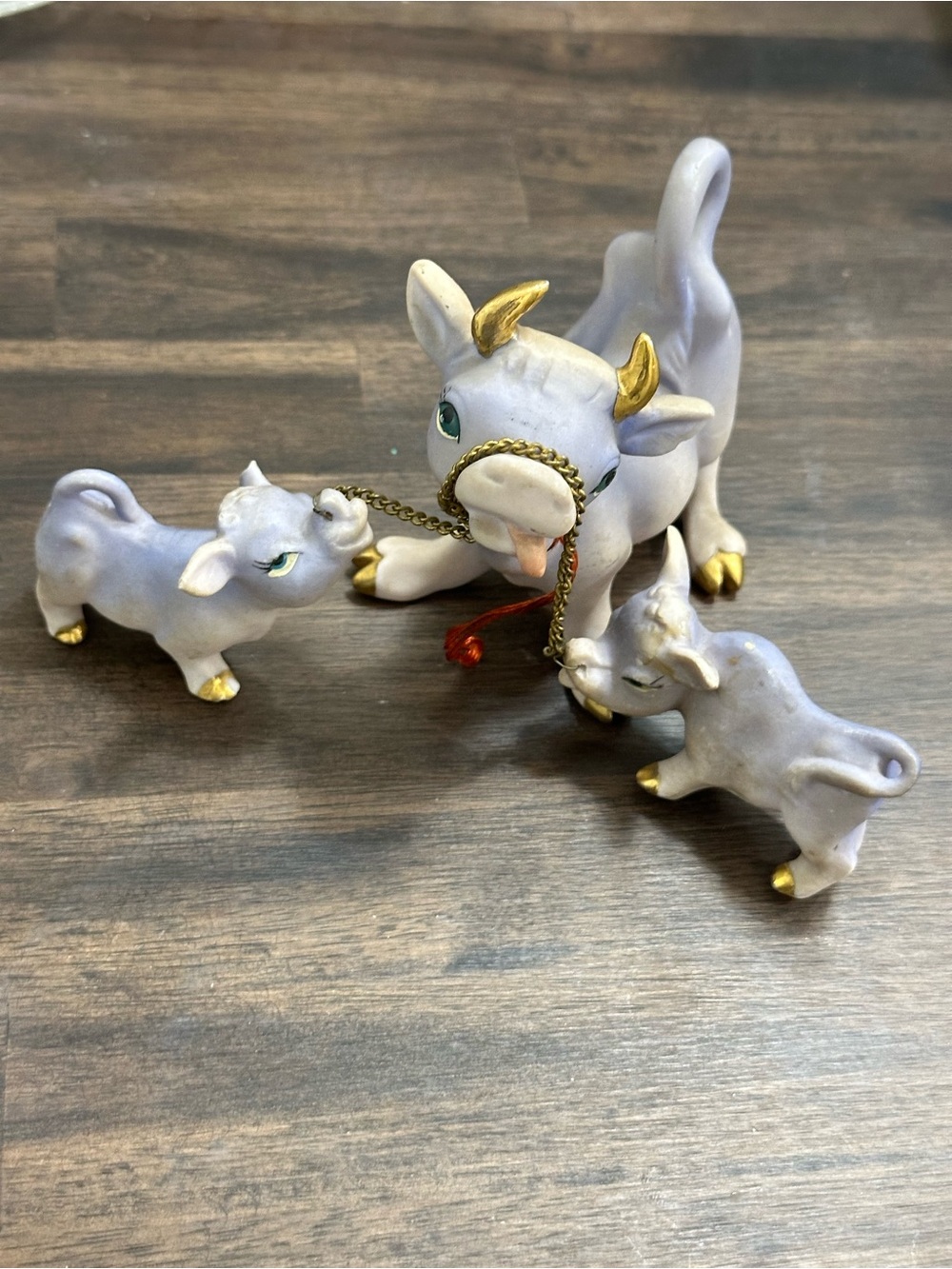 purple ceramic cow and calves figurine set on a chain